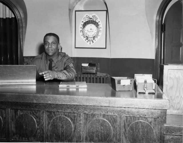 James Griffin, sitting at his desk in police headquarters in the 1960s. Courtesy MnHS