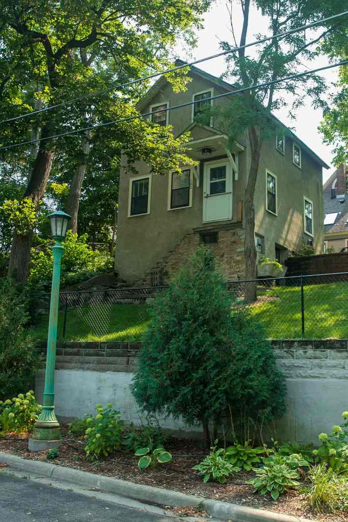 The house at 102 Langford Park (the street) is close to two full stories above the road. Notice how an exterior stairway was removed from the door to the sidewalk.