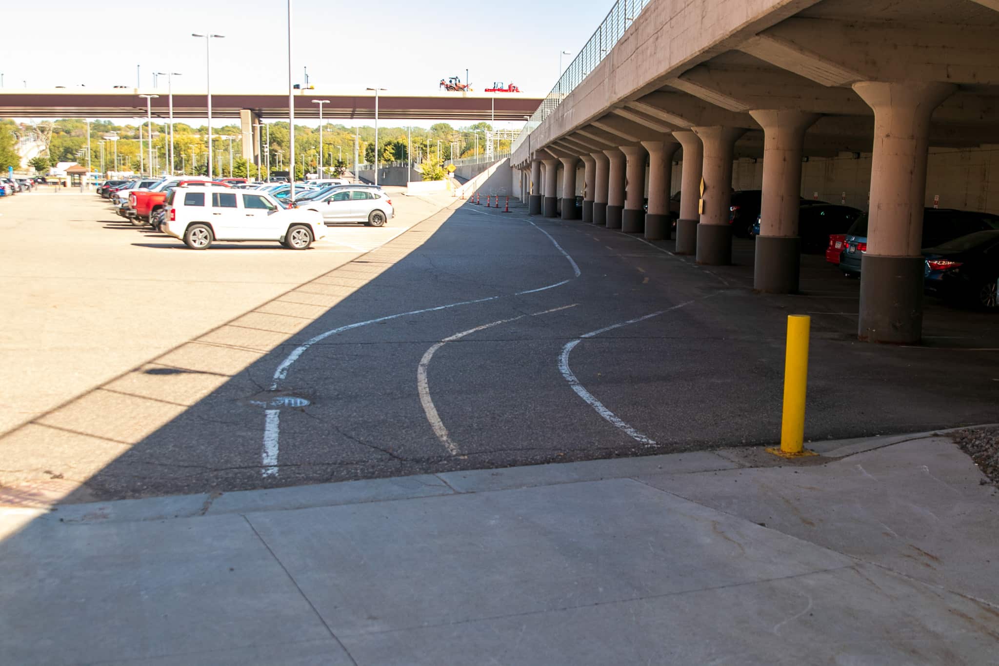 This surface lot, called Union Depot Lot D, isn’t restricted to depot use. I’ve parked here several times on visits to the nearby farmers market. The concrete pillars on the right are part of the support system for the ramps that Metro Transit buses use to access the depot.