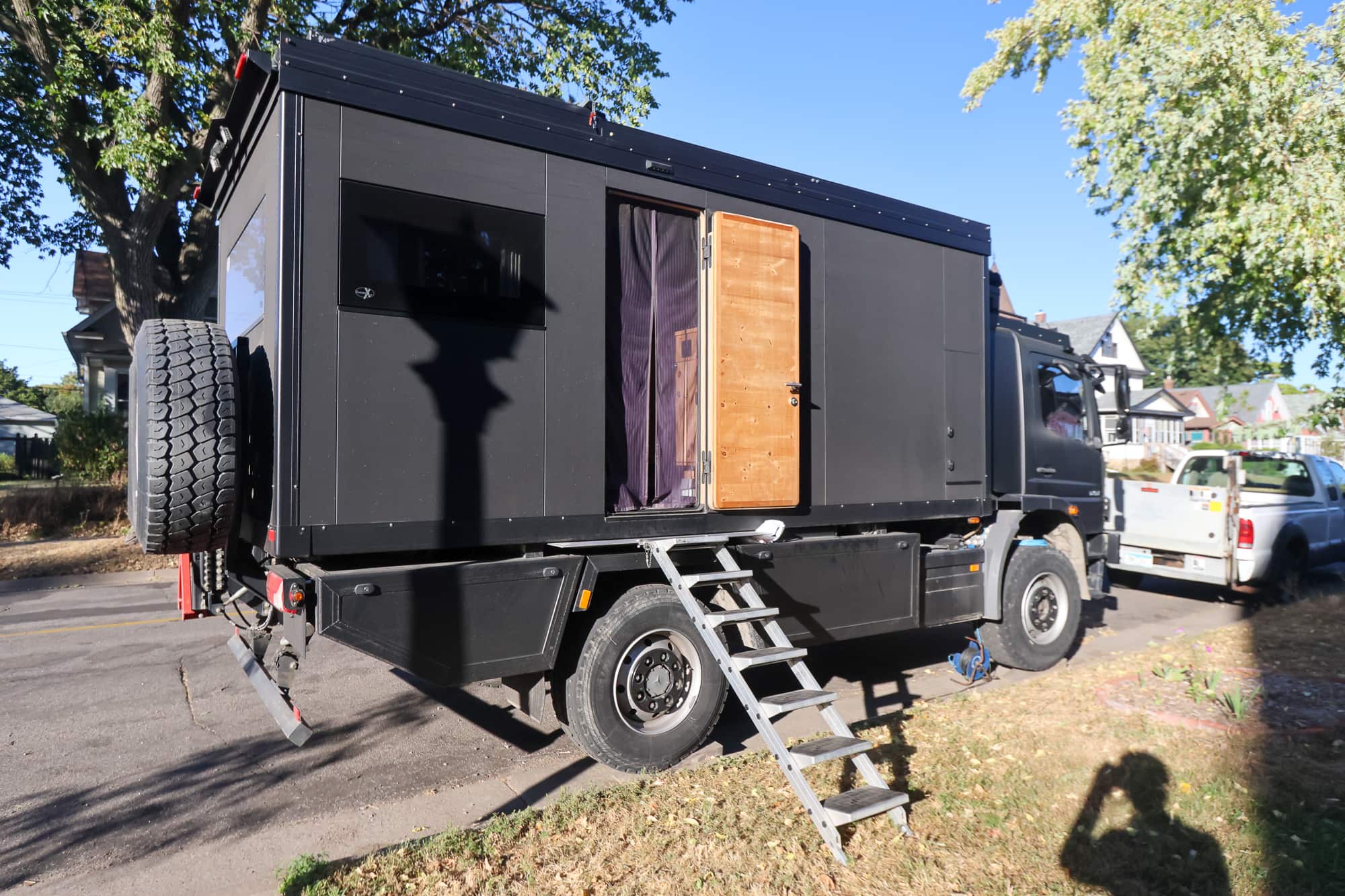 Mercedes RV with side door open and ladder to the ground